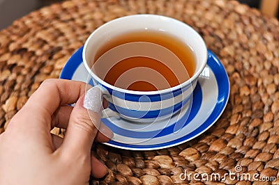 close up of cup of tea with blue stripes at home ,teatime and relax Stock Photo