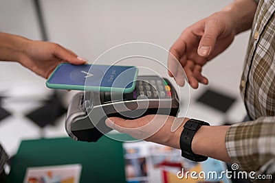 Close-up of a customer doing a successful payment via PayPass Stock Photo