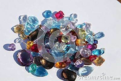 Close up of cut gemstones piled on paper Stock Photo