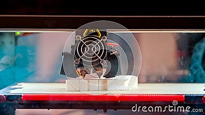 Close-up of 3d printer in process of creating some white shape figure. Stock Photo