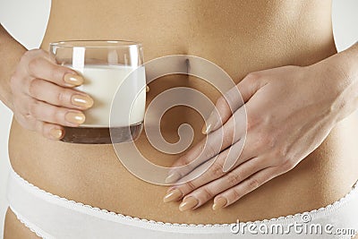 Close Up Of Dairy Intolerant Woman Holding Glass Of Milk Stock Photo