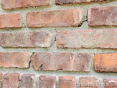 Close up of damage to red brick and mortar wall Stock Photo