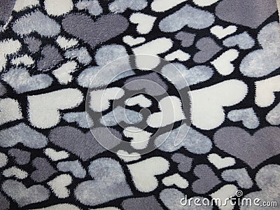 Close-up of dark and white hearts on black synthetics. Stock Photo