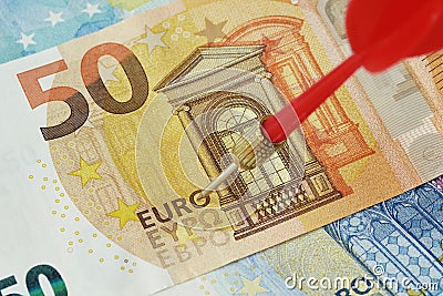 Close-up of dart arrow with euro banknotes Stock Photo