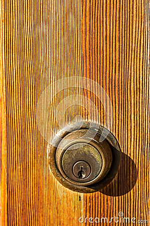 Close-Up of Deadbolt Lock on Brown Door Stock Photo