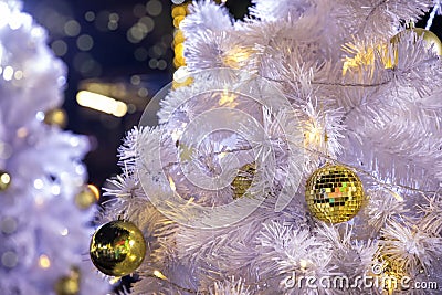 Close up decorated outdoor white Christmas tree with colorful li Stock Photo