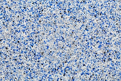 Close up of decorative quartz sand epoxy floor or wall coating with blue, grey, white and black coloured particles Stock Photo