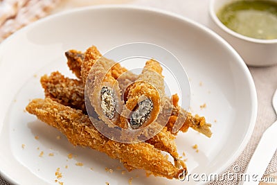 Close up Deep fried Capelin Fish (Shishamo),Thai fried battered egg fish in white plate. Stock Photo