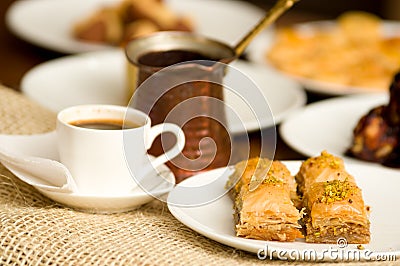 Close up of a delicious breakfast of traditional turkish food baklava with pistachio and a white cup of coffe Stock Photo