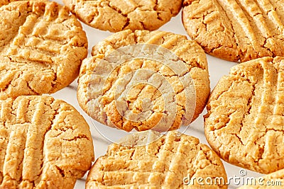 Close up delicious homemade peanut butter cookies on cooling rack. White background. Healthy snack concept. Macro photo Stock Photo