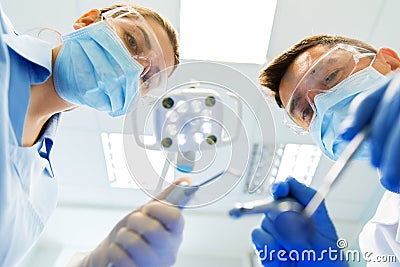 Close up of dentist and assistant at dental clinic Stock Photo