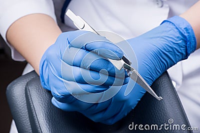 Close-up. Dentist holding reverse tweezers. Orthodontic treatment Stock Photo