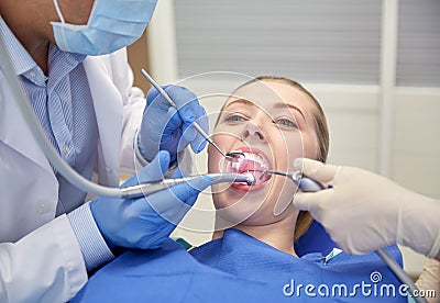 Close up of dentist treating female patient teeth Stock Photo