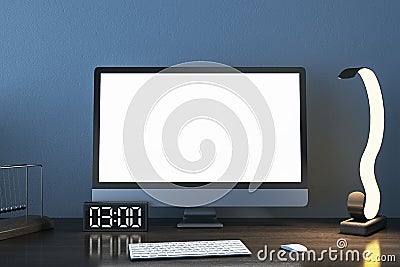 Close up of designer desktop with empty white mock up computer monitor, supplies and various items on blue concrete wall Editorial Stock Photo