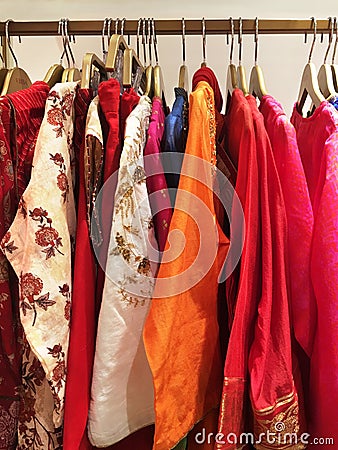Close up of designer indian garments for woman displaying on the rack. Stock Photo