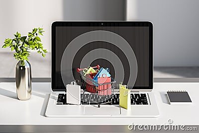 Close up of desktop with laptop and tiny shopping carts on keaybord. Blurry wall background. Online shopping and commerce concept Editorial Stock Photo