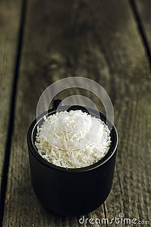 Dessicated Coconut flakes in a small cup Stock Photo