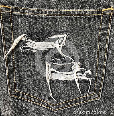 Close up of destroyed torn denim jeans patch Stock Photo