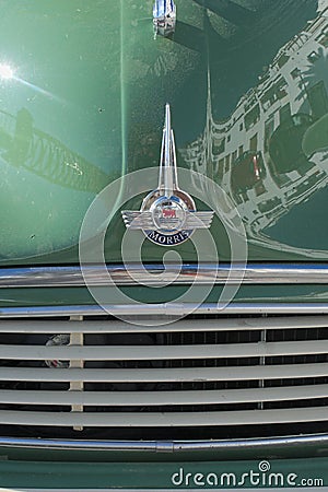 Close up detail of the badge and bonnet of the classic English car, the Morris Minor. Editorial Stock Photo