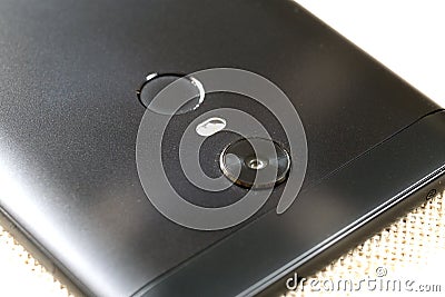 Close-up detail of cellphone with security thumb fingerprint scanning device and camera. Modern technology security and smartphone Stock Photo