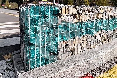 Close-up detail of new modern beautiful gabion fence with metal cage filled by crushed stone and shattered artificial Stock Photo