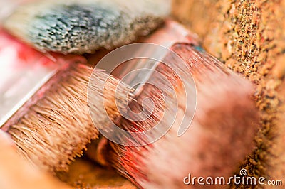 Close up of detail paint brushes over a color palette in a studio, in a blurred background Stock Photo