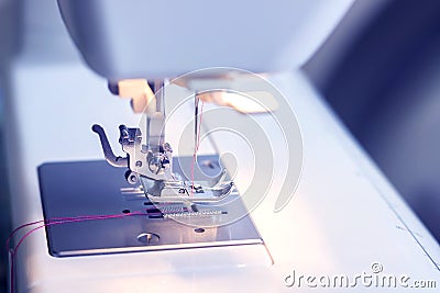 Close-up detail of the sewing machine. Blue tone Stock Photo