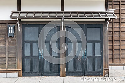 Close up detail sliding door of Edo period architecture style with leaves less tree in Noboribetsu Date JIdaimura Historic Village Stock Photo