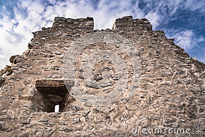 Close up detail of stone medieval castle wall with window in blue sky with clouds, crni kal, slovenia Stock Photo