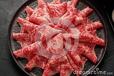 A close up detailed image of sliced Japanese wagyu beef in a ceramic plate prepared for Shabu Shab Stock Photo