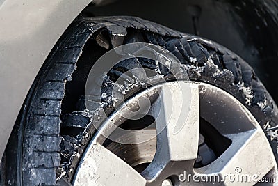 Blown out tire with exploded, shredded and damaged rubber Stock Photo