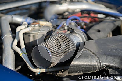 a close up details in the motor engine of a vehicle sport racer car with opened hood Stock Photo