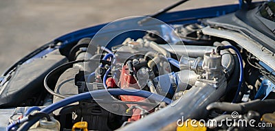 a close up details in the motor engine of a vehicle sport racer car with opened hood Stock Photo
