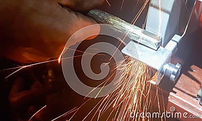 Close up details of sparks, industrial worker using angle grinder Stock Photo