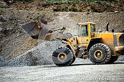 Close up details of wheel loader with scoop working on construction site Stock Photo