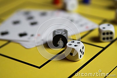 Close up of dices and cards on yellow game board Stock Photo