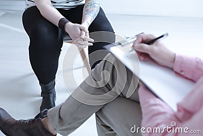 Close-up on difficult teenager with tattoo during therapy with c Stock Photo