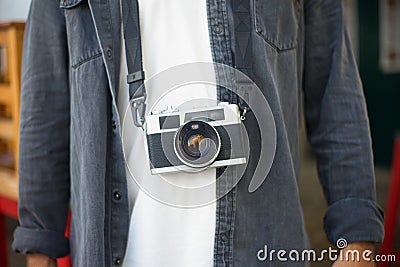Close-up of digital photo camera on mans body Stock Photo