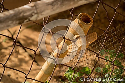 Close-up Dirty PVC Pipe/ Plastic Faucet - Rusty Old Wire Fence - Abandoned Junk - Sunny Stock Photo