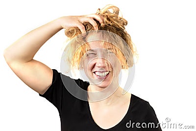 Close-up of a disheveled girl, laughing, holding her head and smoothing her hair. Isolated on a white background. The Stock Photo