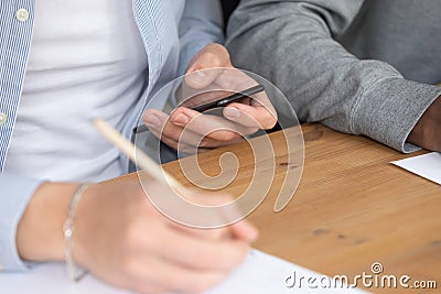 Guy studying writing info read on smartphone using educational website Stock Photo