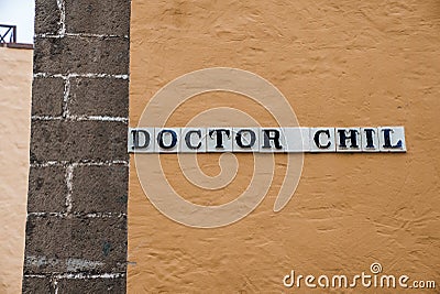 Close-up of doctor chil signboard on old wall of building in old town Stock Photo