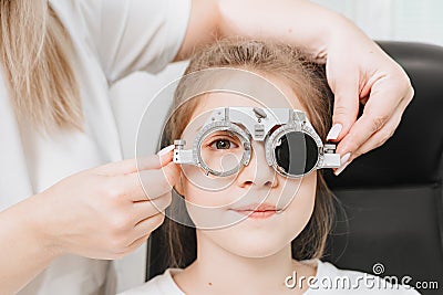 close up. doctor diagnoses little girl& x27;s vision and makes selection of lenses. Stock Photo