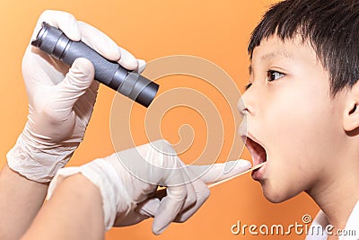 Close up doctor examining throat of patient with tongue depressor Stock Photo