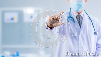 Close up of doctor hand holding Vaccines bottle used for the cure or treatment trial, clinical research of Covid-19 Stock Photo