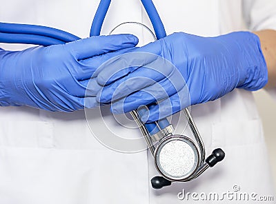 Close up of doctor hands in gloves with stethoscope, medical exam concept Stock Photo