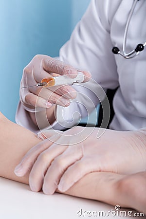 Close-up of doctor's hand with syringe Stock Photo