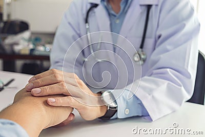 Close up of doctor touching patient hand for encouragement and e Stock Photo