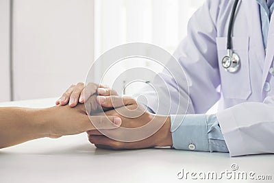 Close up of doctor touching patient hand for encouragement and empathy on the hospital, cheering and support patient, Bad news, me Stock Photo