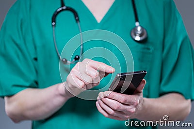 Close up of doctor in uniform using phone Stock Photo